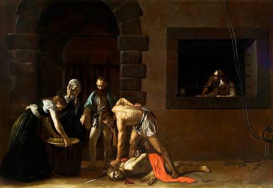 La firma nel sangue di Caravaggio: il dettaglio decisivo nella Decollazione di san Giovanni Battista